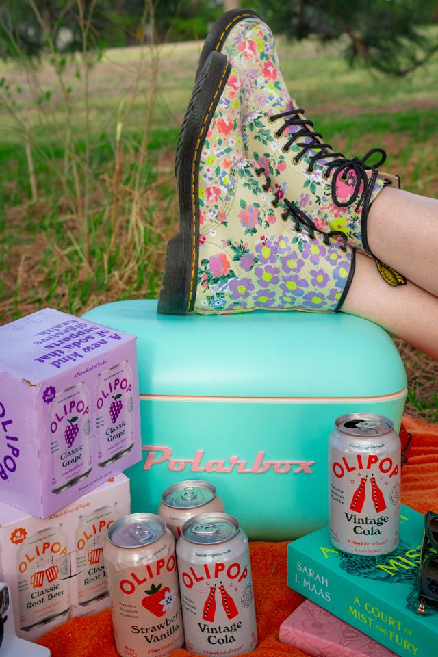 Variety of Olipop prebiotic soda cans including caffeine-free and Vintage Cola flavors